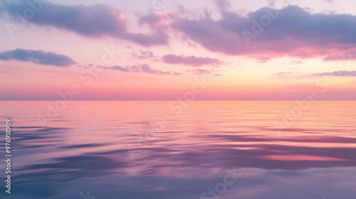 A serene twilight scene with the last light of day fading into a sky filled with pink, purple, and orange, reflecting off a calm sea.