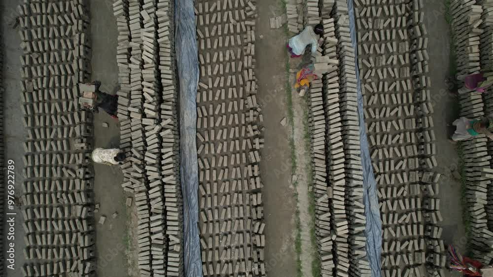 Aerial view of workers carrying bricks at a brick factory, Bahubal, Bangladesh