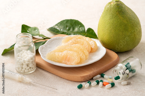 Fresh pomelo fruit and medicine adverse drug reaction interaction design concept.