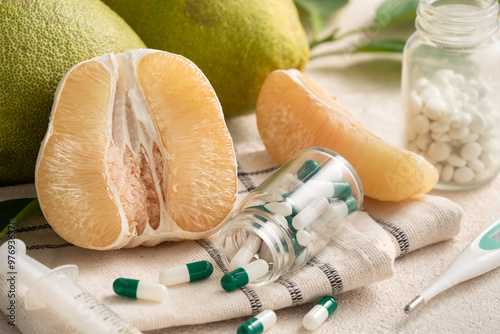 Fresh pomelo fruit and medicine adverse drug reaction interaction design concept.