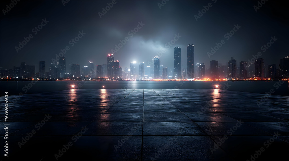 Obraz premium A nighttime cityscape with a view of a modern city skyline The city is illuminated by lights, and the sky is filled with fog