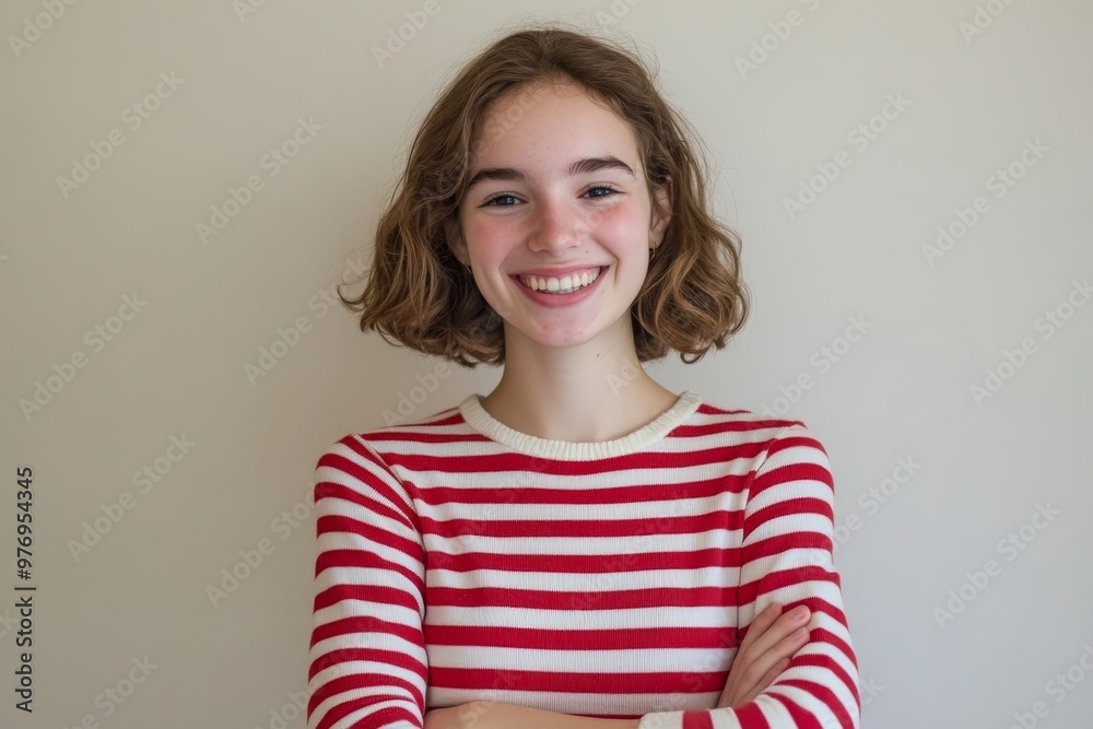 The portrait depicts a laughing young woman wearing a shirt with red-white stripes against a white backdrop. The portrait depicts a laughing young woman wearing a shirt with red-white stripes against a white backdrop.