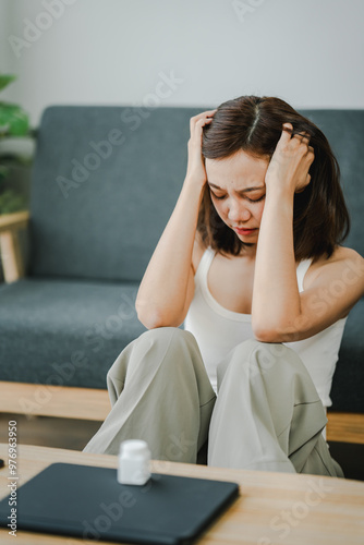 A young woman is sick and dependent on medicine. Young woman takes migraine medicine to relieve symptoms Have a headache and high fever from being sick Health concept
