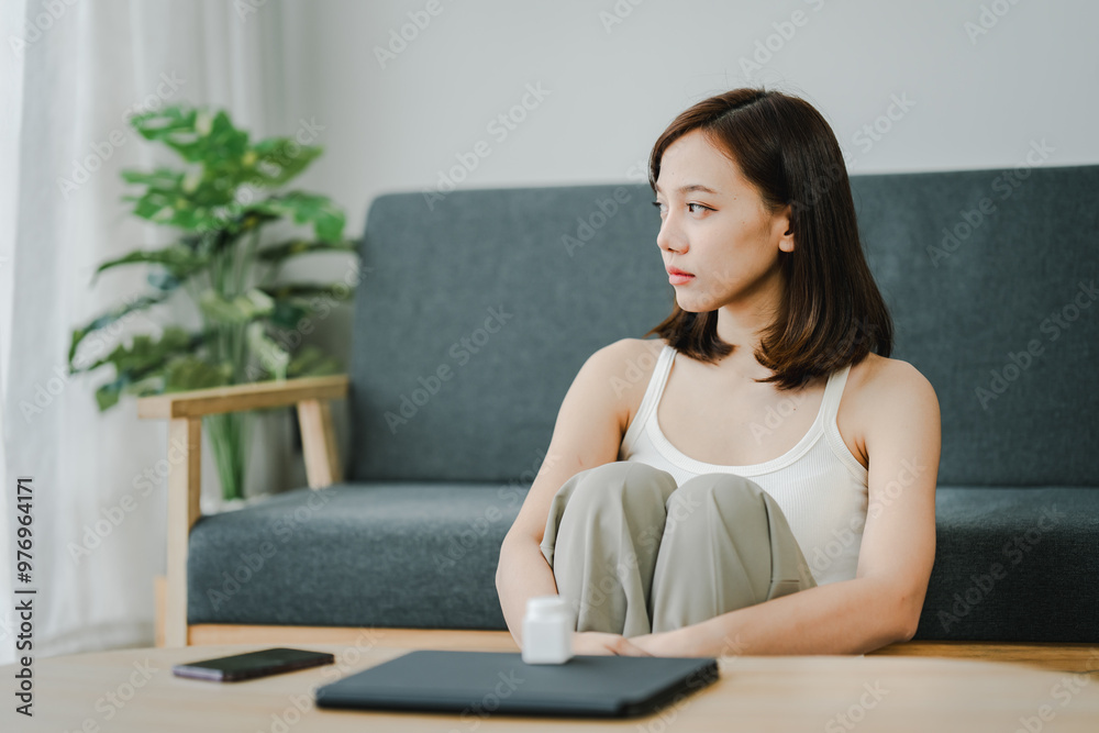 A young woman is sick and dependent on medicine. Young woman takes migraine medicine to relieve symptoms Have a headache and high fever from being sick Health concept