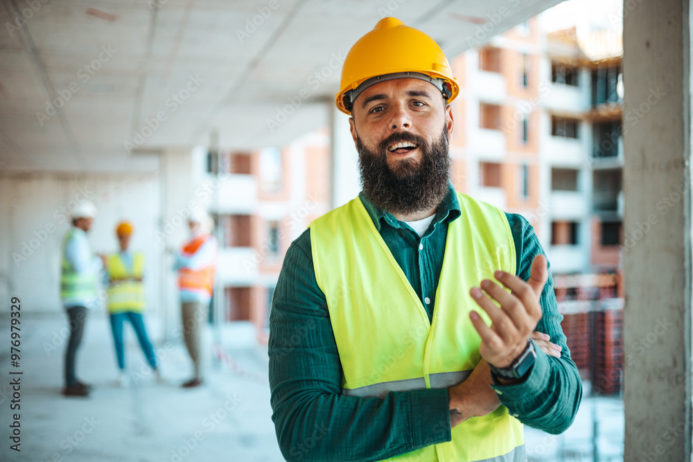 Confident Construction Worker at Building Site With Team Confident Construction Worker at Building Site With Team