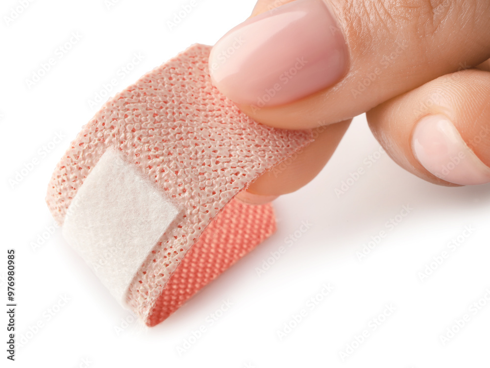 Εκτύπωση καμβά Woman putting medical adhesive bandage on white background, closeup