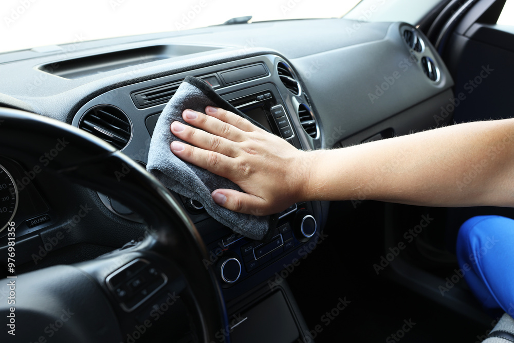 Man cleaning center console with rag, closeup Man cleaning center console with rag, closeup