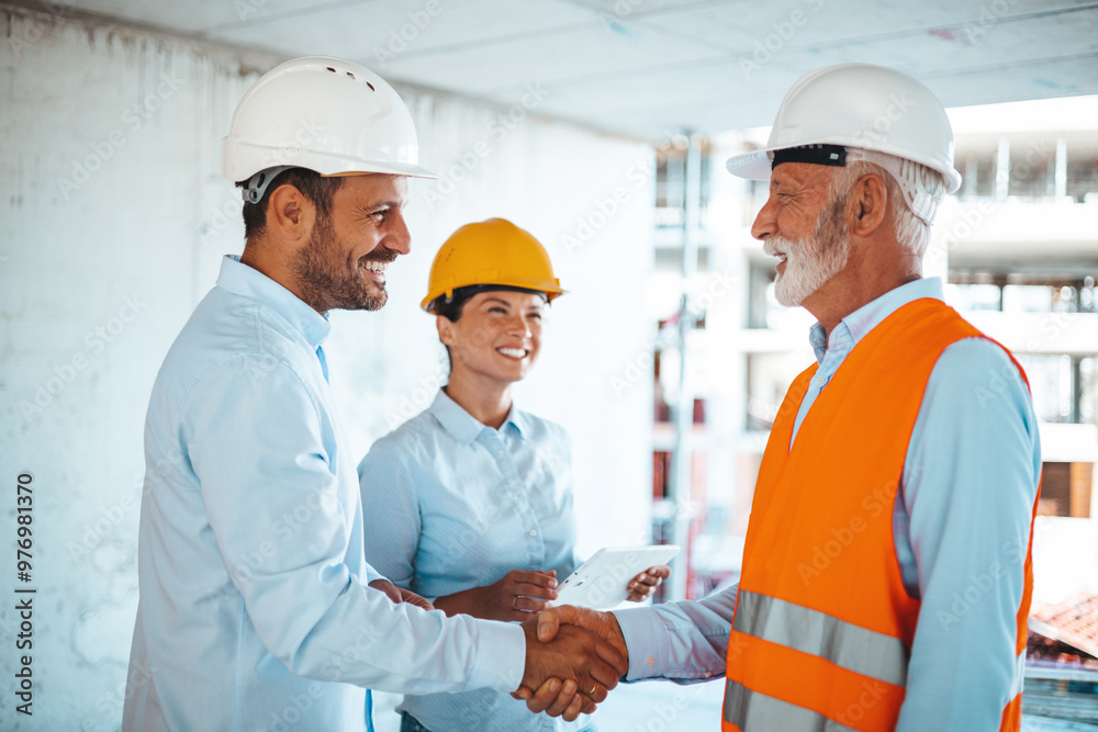 Construction Team Discussing Project at Building Site Construction Team Discussing Project at Building Site