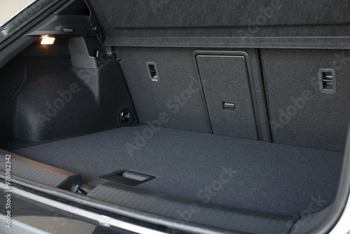 Grey soft car boot liner mat in trunk of auto photo