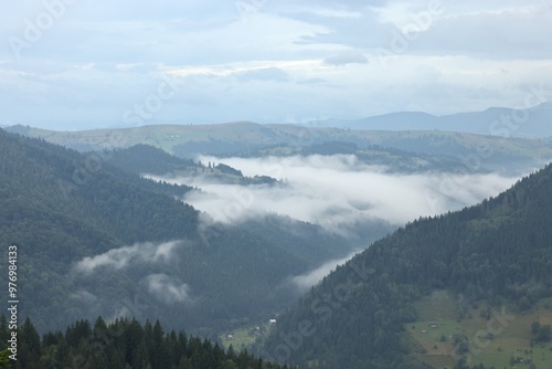 Picturesque view of beautiful mountains covered with fog