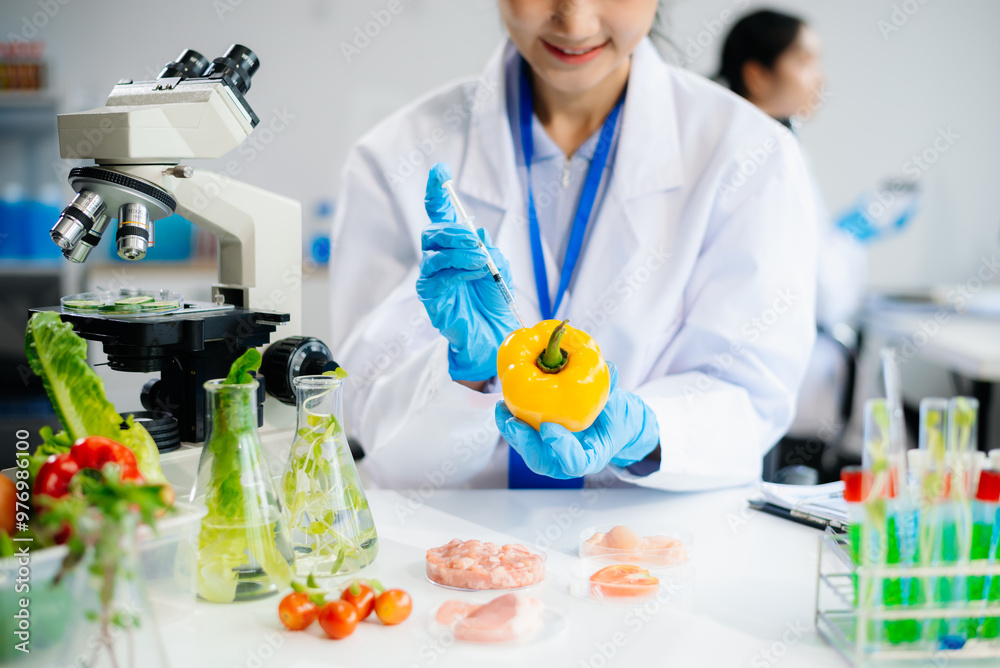 Fototapeta premium Two Asian scientists in a lab conducting food research using a microscope and lab equipment, showcasing innovation in food science