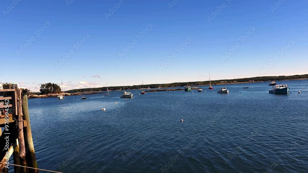 Pier at Georgetown, Maine showing islands and boats and blue skies on ocean Pier at Georgetown, Maine showing islands and boats and blue skies on ocean