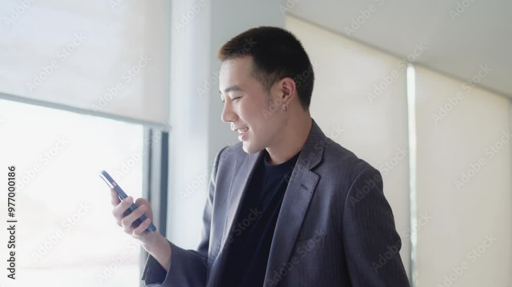Young adult male use smart phone at workplace for online web internet search Young adult male use smart phone at workplace for online web internet search