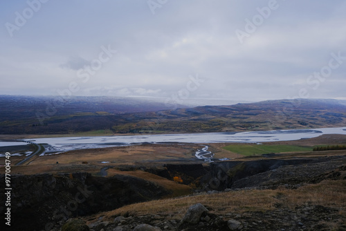 Views of the Logurinn river from the mountains, on an autumn day, with snowy forests and meadows, near the Litlanesfoss waterfall, in Iceland photo