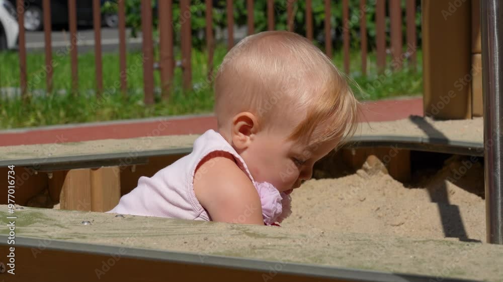 A joyful toddler explores a sandpit, digging and playing in the warm sunshine at a community park while adults nearby enjoy the pleasant day A joyful toddler explores a sandpit, digging and playing in the warm sunshine at a community park while adults nearby enjoy the pleasant day