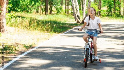 Wallpaper Mural Child riding a bike in summer park. Children learning to drive a bicycle on a driveway outside. Kid riding bike. Child on bicycle, bike outdoor. Torontodigital.ca