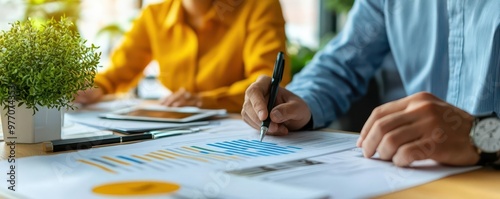 Obraz na płótnie A financial advisor presenting energy-saving solutions to business executives, energy efficiency audit concept, Energy Efficiency Audit w salonie