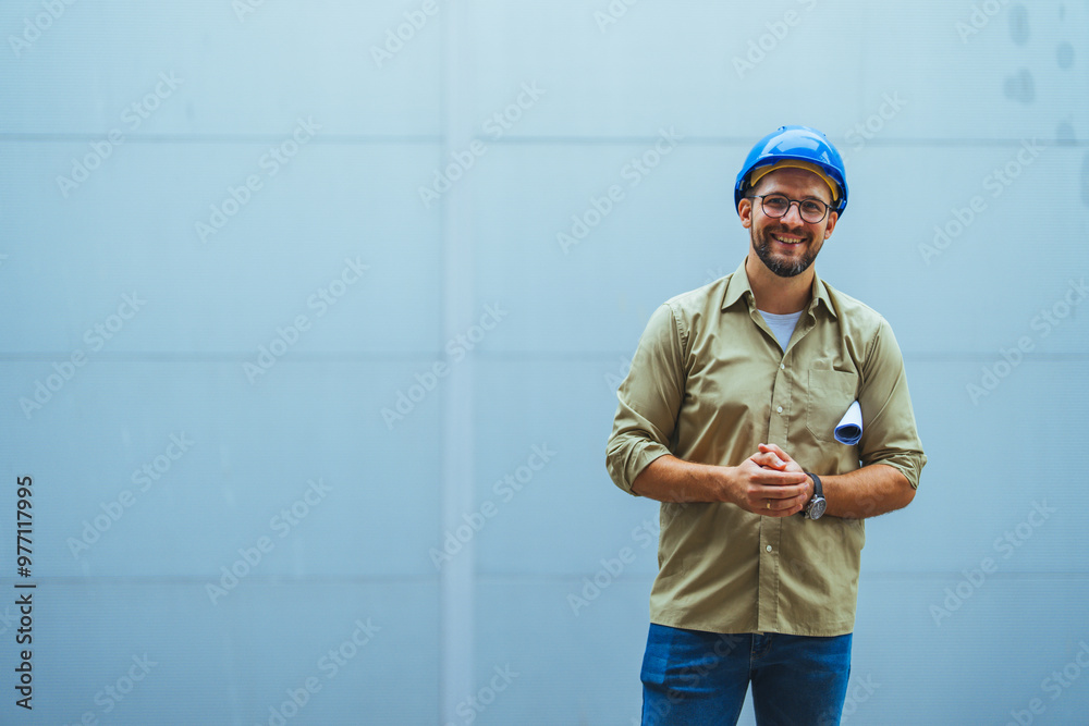 Smiling Engineer Wearing Hard Hat With Blueprints in Hand Smiling Engineer Wearing Hard Hat With Blueprints in Hand