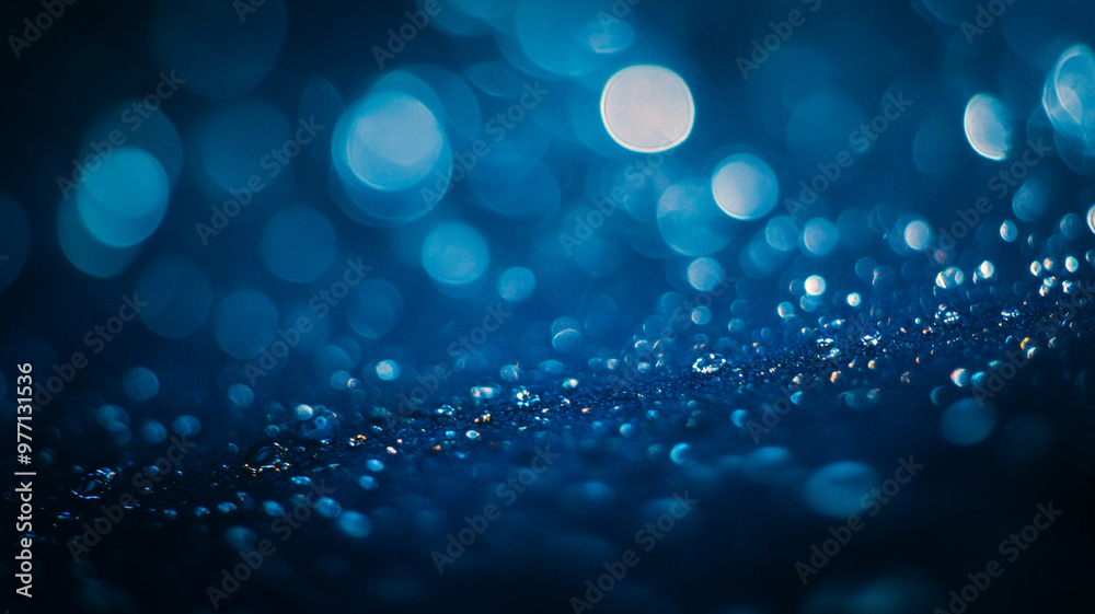 Sparkling water droplets create a mesmerizing pattern in a blue light ambiance Sparkling water droplets create a mesmerizing pattern in a blue light ambiance