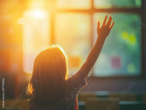 A Back View of an Elementary School Student Raising Their Hand in the Classroom, with Bright Light Streaming in from the Window, Capturing a Lively Learning Moment