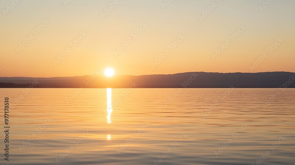 A soft, glowing sunset over a lake with a clear sky for text A soft, glowing sunset over a lake with a clear sky for text