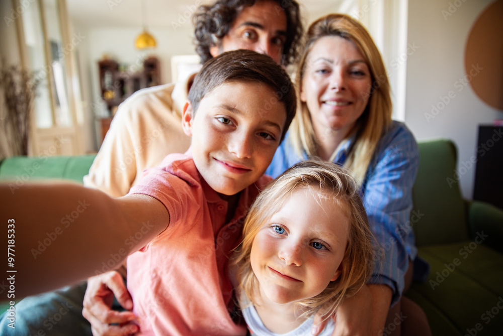 Family taking a fun selfie on the couch at home Family taking a fun selfie on the couch at home