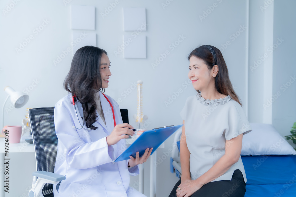 Fototapeta premium A doctor is giving advice to a patient who is coming for treatment about she's illness.