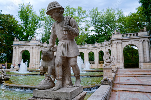 Scene at the historic fairytale fountain with figures from the Grimm Brothers' stories in Berlin-Friedrichshain. photo
