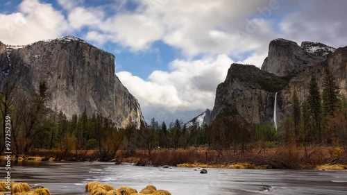 Time Lapse of the the clouds moving over the amazing landscape of Yosemite National Park in California. Merced River in the foreground.
