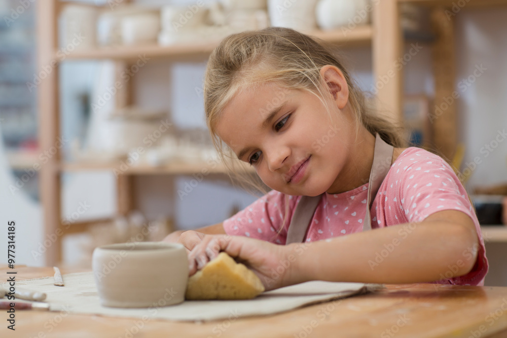 child girl makes a cup of clay crafts pottery school. child sculpts from clay child girl makes a cup of clay crafts pottery school. child sculpts from clay