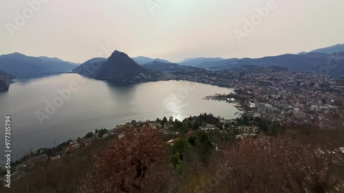 The hazy sunset over Lake Lugano and Monte San Salvatore, Ticino, Switzerland photo