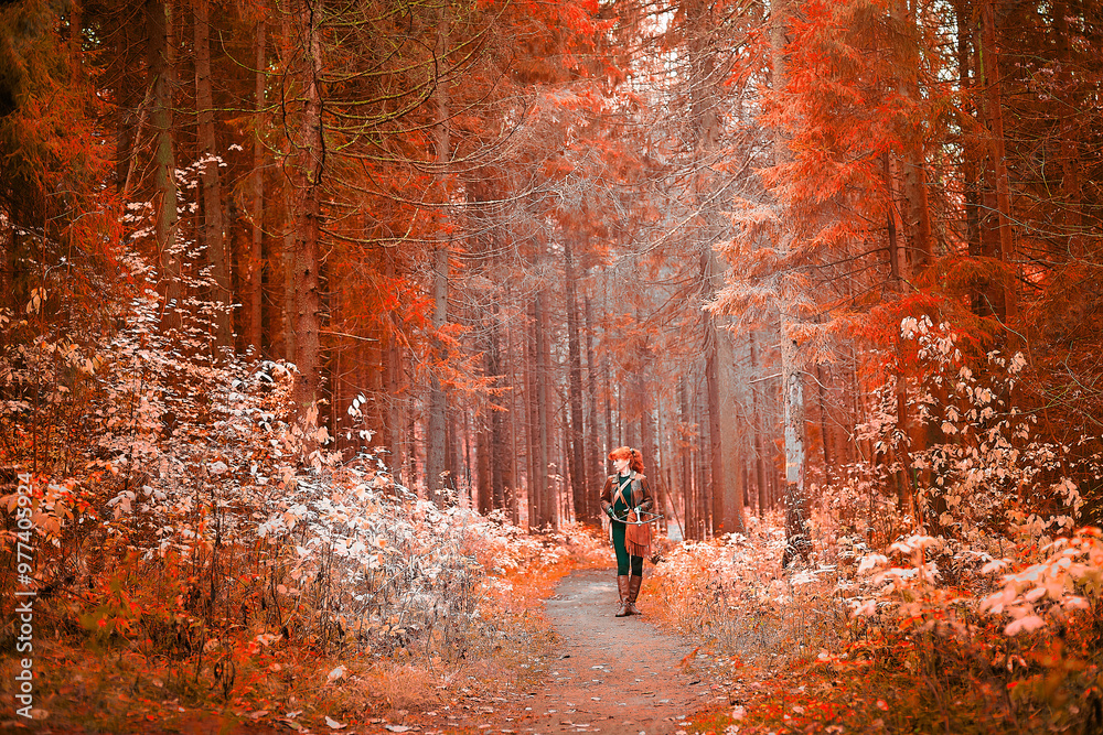 Fototapeta premium Mature model portraying a royal huntress with red curve hair is hunting with a crossbow in the in vibrant autumn forest in a thematic photo shoot
