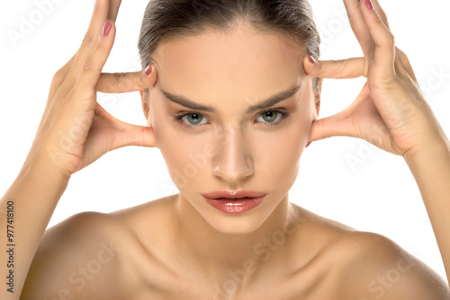 Photography beautiful young woman tightens her face with her fingers.