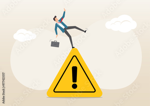 businessman slip falling on exclamation symbol beware