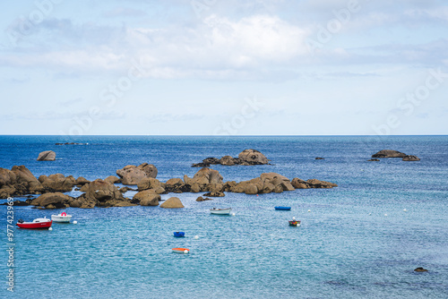 Natural landscape of the rocky beach and seascape along the Brittany coastline, Côte de granite rose or Pink Granite Coast in France photo