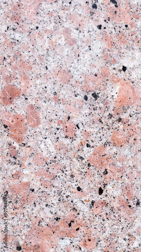 Textured surface of pink and gray granite with intricate speckles and patterns Textured surface of pink and gray granite with intricate speckles and patterns