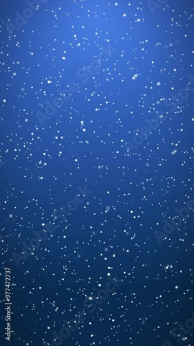 Vertical video animation of falling snow on blue background - seamless loop - Christmas and vacation concept.