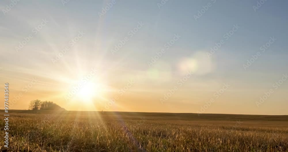 4K flat hill meadow timelapse at the autumn sunset time. Wild nature and rural grass field. Sun rays and yellow grass. Motorised dolly slider and panorama movement