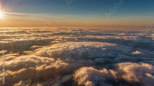 Aerial view of sunset clouds with sun rays shining through fog, capturing a detailed and picturesque cloudscape.