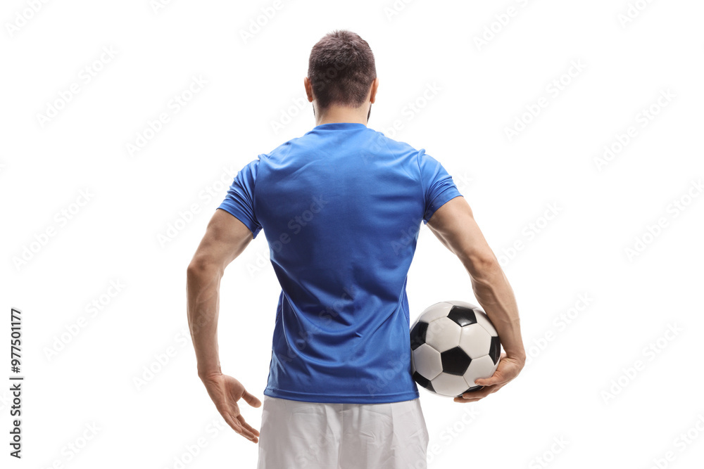 Rear view shot of a soccer player with a ball under arm Rear view shot of a soccer player with a ball under arm