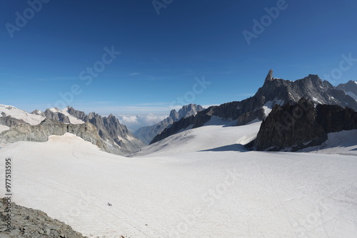 The Punta Helbronner glacier at 3,466 m on the Mont Blanc massif with climbers roped on the glacier. Aosta Valley, Italy.