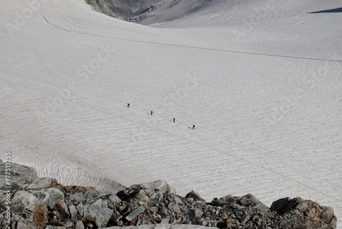 Climbers roped together on the Punta Helbronner glacier at 3,466 m on the Mont Blanc massif in the Aosta Valley, Italy.