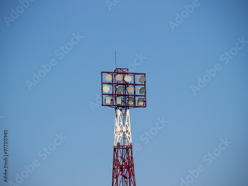 Stadium light tower decorated with a bright blue sky background