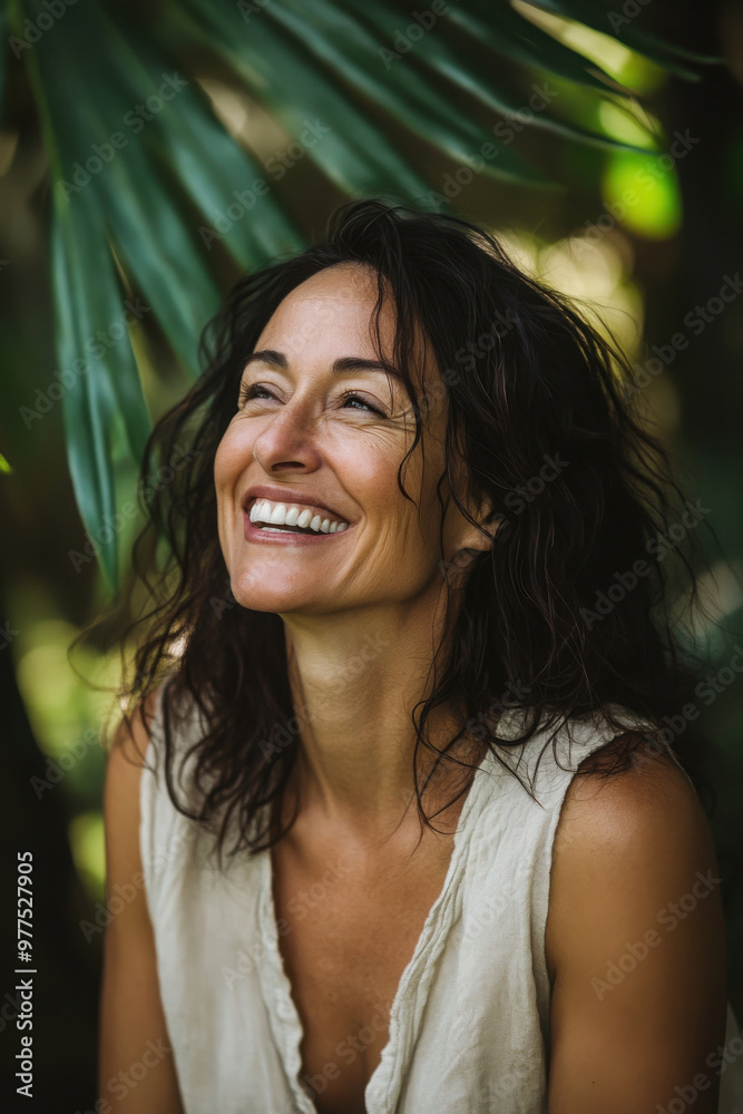 Smiling woman with curly hair enjoying nature, surrounded by green leaves, radiating happiness and a sense of peace Smiling woman with curly hair enjoying nature, surrounded by green leaves, radiating happiness and a sense of peace