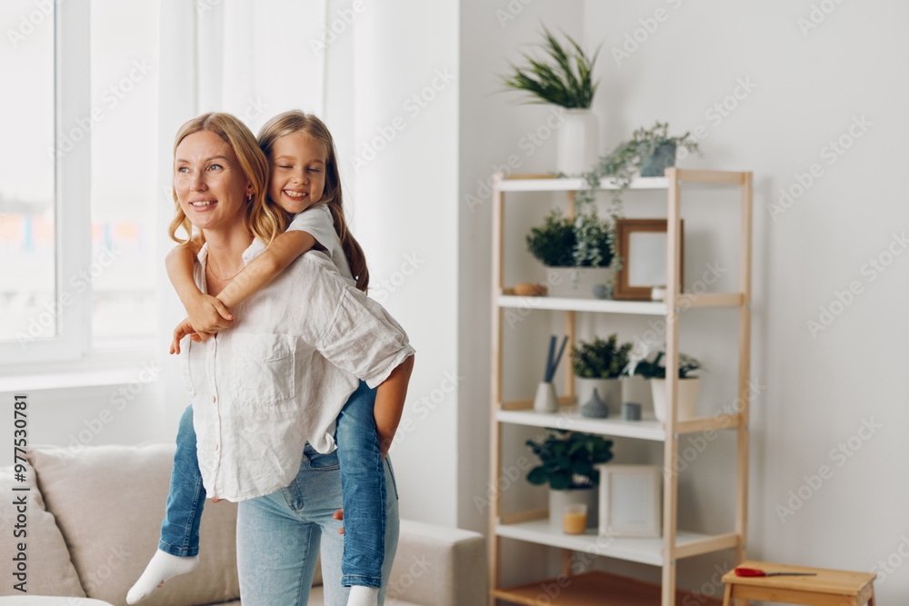 Mother and daughter bonding in cozy living room with comfortable couch and organized bookshelf in the background Mother and daughter bonding in cozy living room with comfortable couch and organized bookshelf in the background