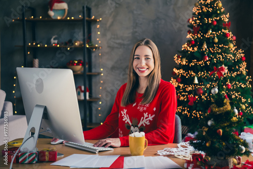 Photo of attractive young woman working computer dressed christmas outfit cozy day light home party decoration interior living room photo