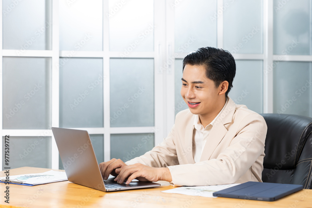 Asian businessman working in his office reviewing work, accessing planning strategy, creative thinking and innovation ideas, happy smiling sitting at desk on laptop computer professional worker. Asian businessman working in his office reviewing work, accessing planning strategy, creative thinking and innovation ideas, happy smiling sitting at desk on laptop computer professional worker.