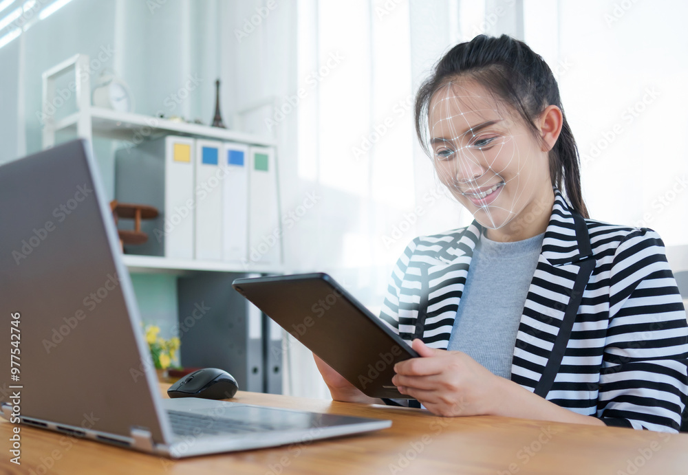 Asian businesswoman using mobile smartphone scanning face ID to unlock tablet computer security with facial recognition technology for identification, with graphical technology illustration. Asian businesswoman using mobile smartphone scanning face ID to unlock tablet computer security with facial recognition technology for identification, with graphical technology illustration.
