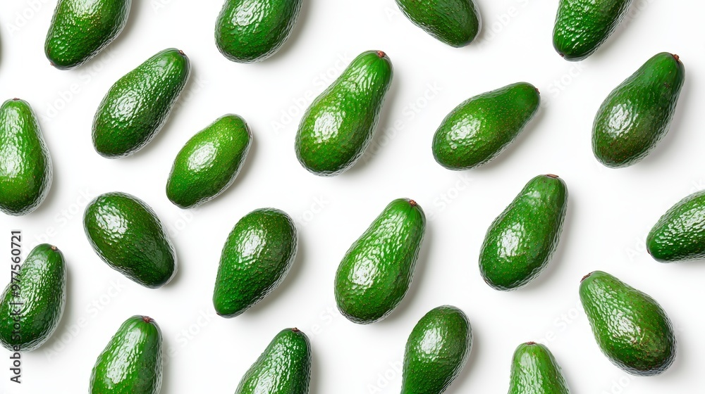 This is a flat lay view of a pattern of avocado slices with the halves isolated on a white background, a summer fruit that is packed with vitamins and nutrients for summer consumption.