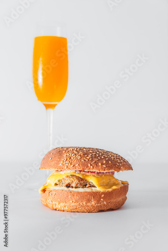 Close-up of burger and french fries on table against white background